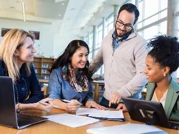 A group of people working on a document together.