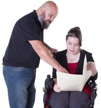 A provider reading a document with another person.