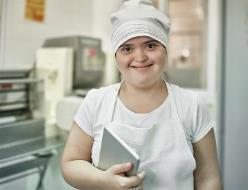A person with disability working in a kitchen. 